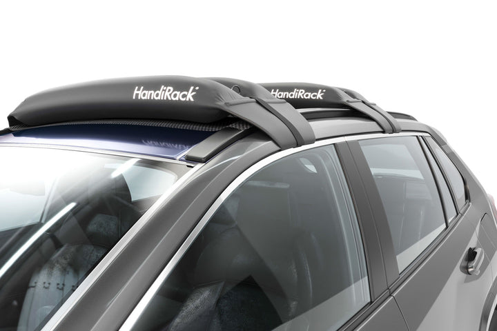Soft and inflatable roof rack system for carrying surfboards